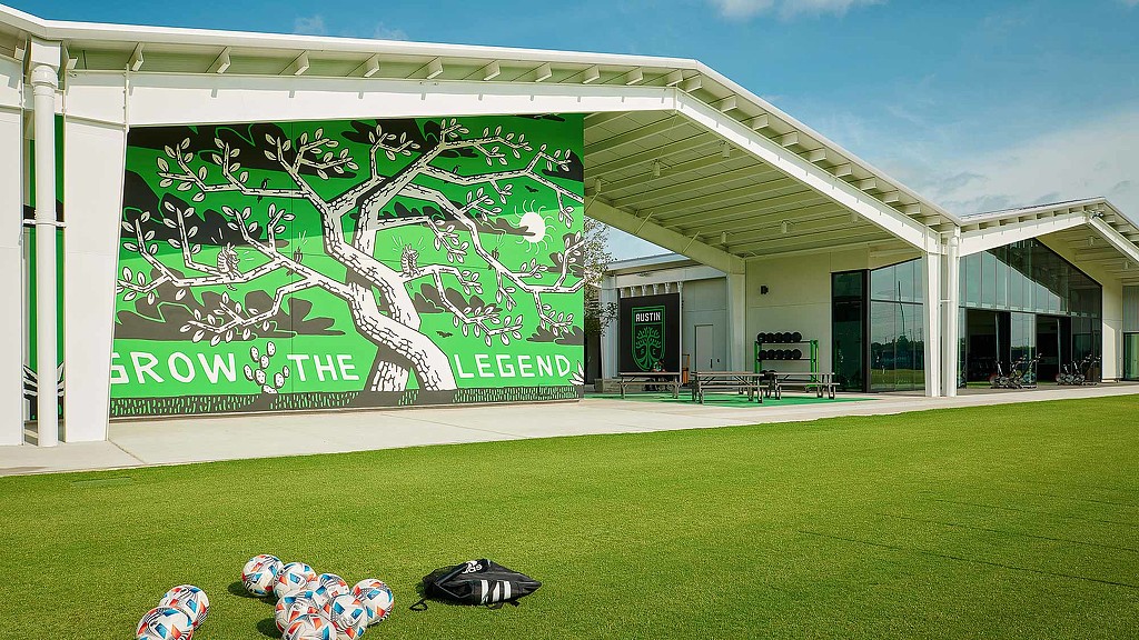 A building with a large green lawn.